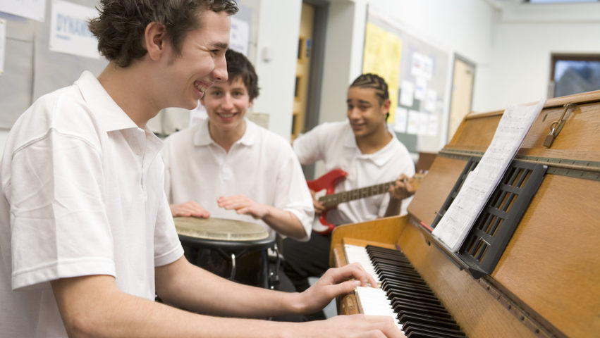 Students playing various instruments in a classroom
